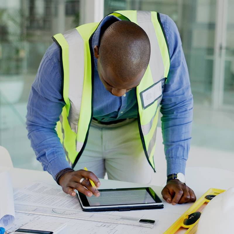 Architect working at table on tablet