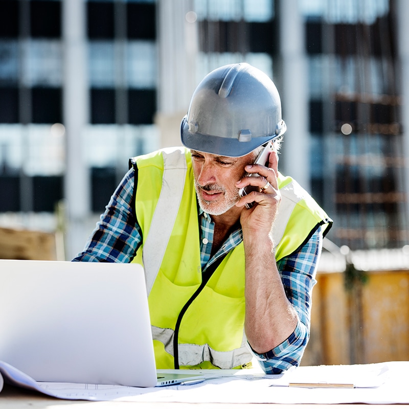 Construction foreman talking on phone 